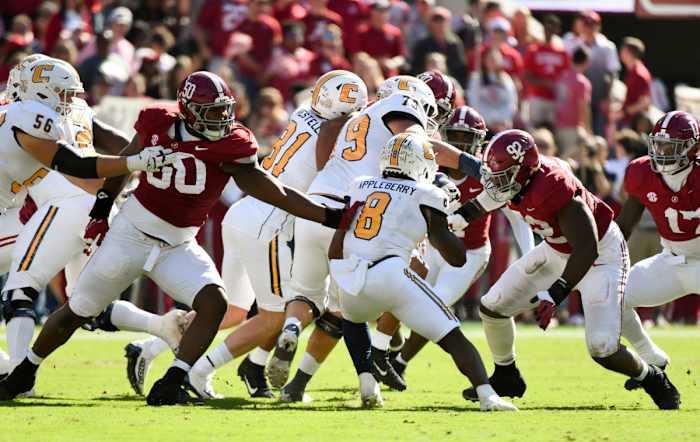 Nov 18, 2023; Tuscaloosa, Alabama, USA; Alabama Crimson Tide defensive lineman Tim Smith (50) and Alabama Crimson Tide defensive lineman Justin Eboigbe (92) close in to tackle Chattanooga Mocs running back Gino Appleberry (8) at Bryant-Denny Stadium. Mandatory Credit: Gary Cosby Jr.-USA TODAY Sports